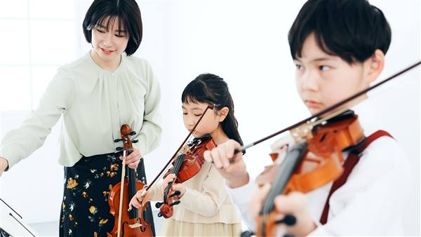 音楽教室で、子どもにバイオリンを教える先生